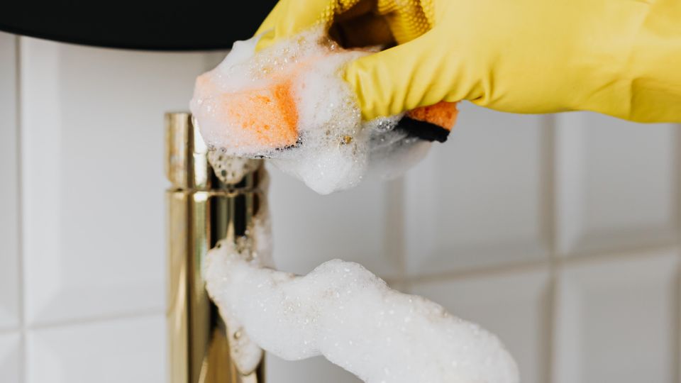 Hand cleaning a bathroom faucet and aerator
